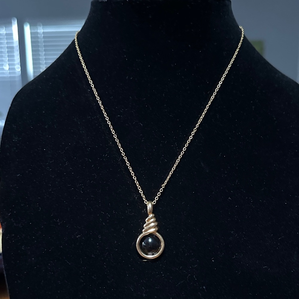 Elegant Gold Pendant Necklace with Black center stone.